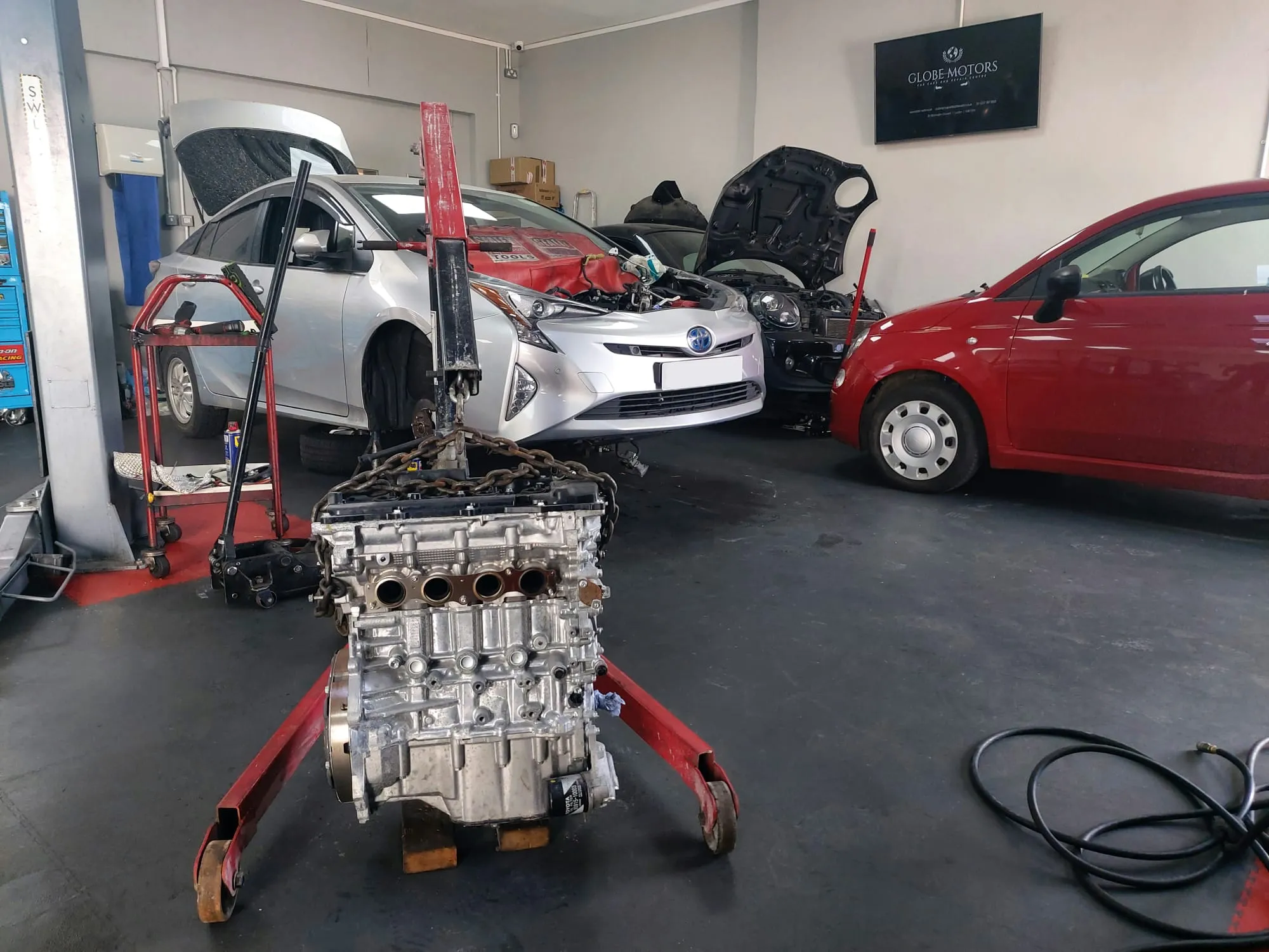 Red and silver car in for repairs