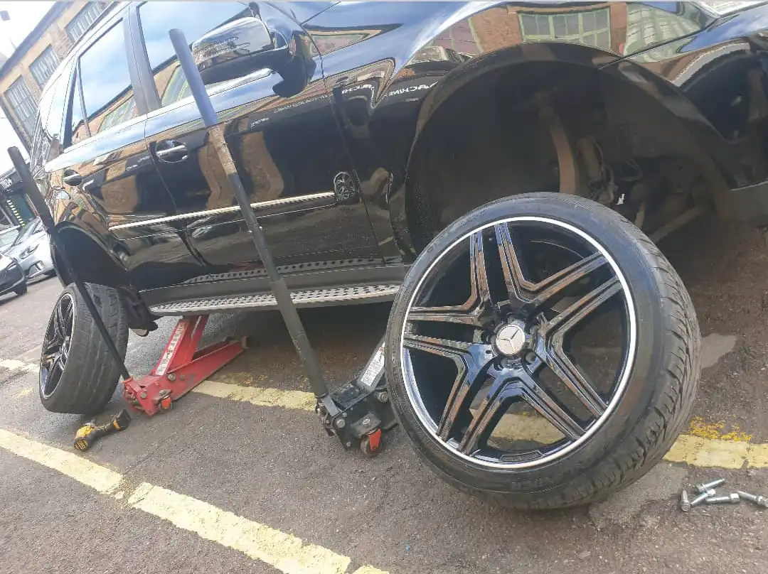 Car on a jack with the wheels removed