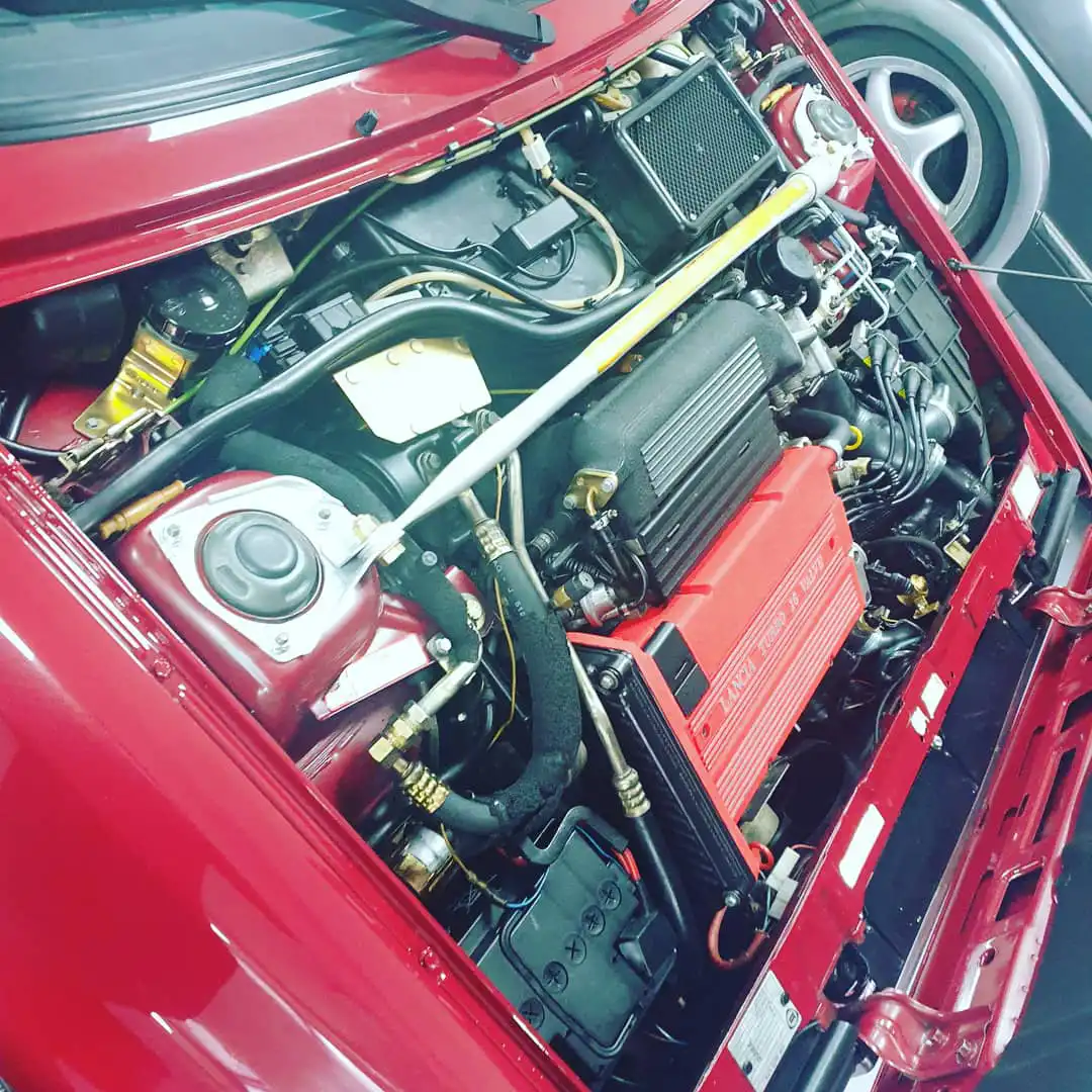 red car with bonnet removed
